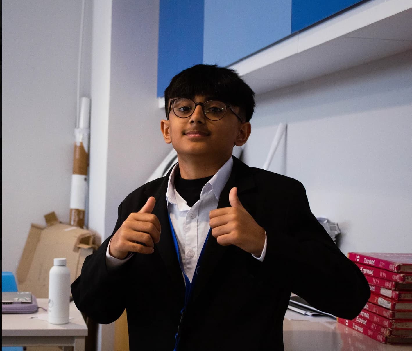 A DHAMUN participant smiling and giving two thumbs up